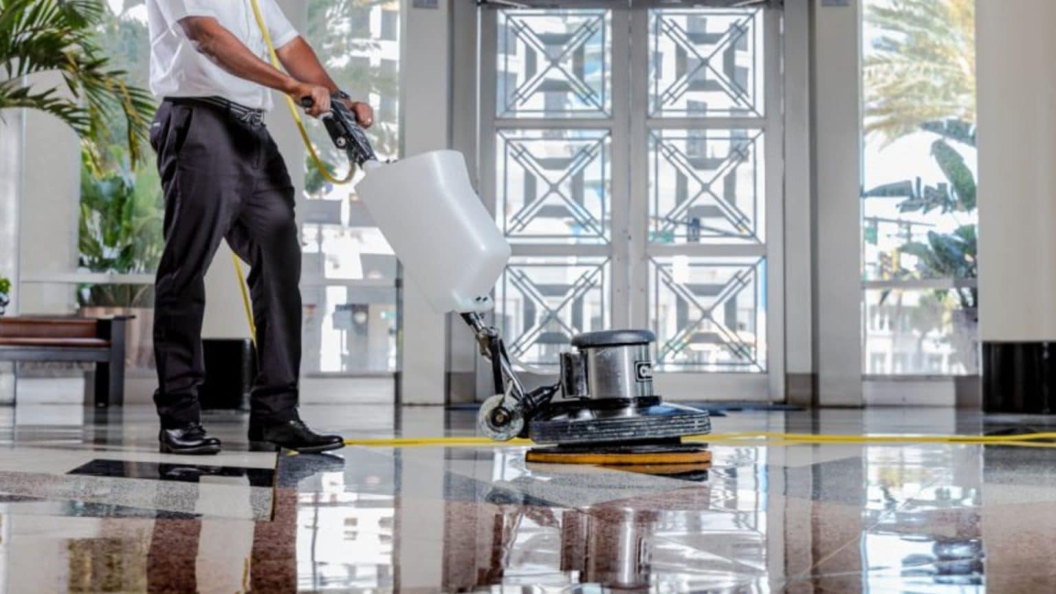 Man with a commercial floor polishing machine